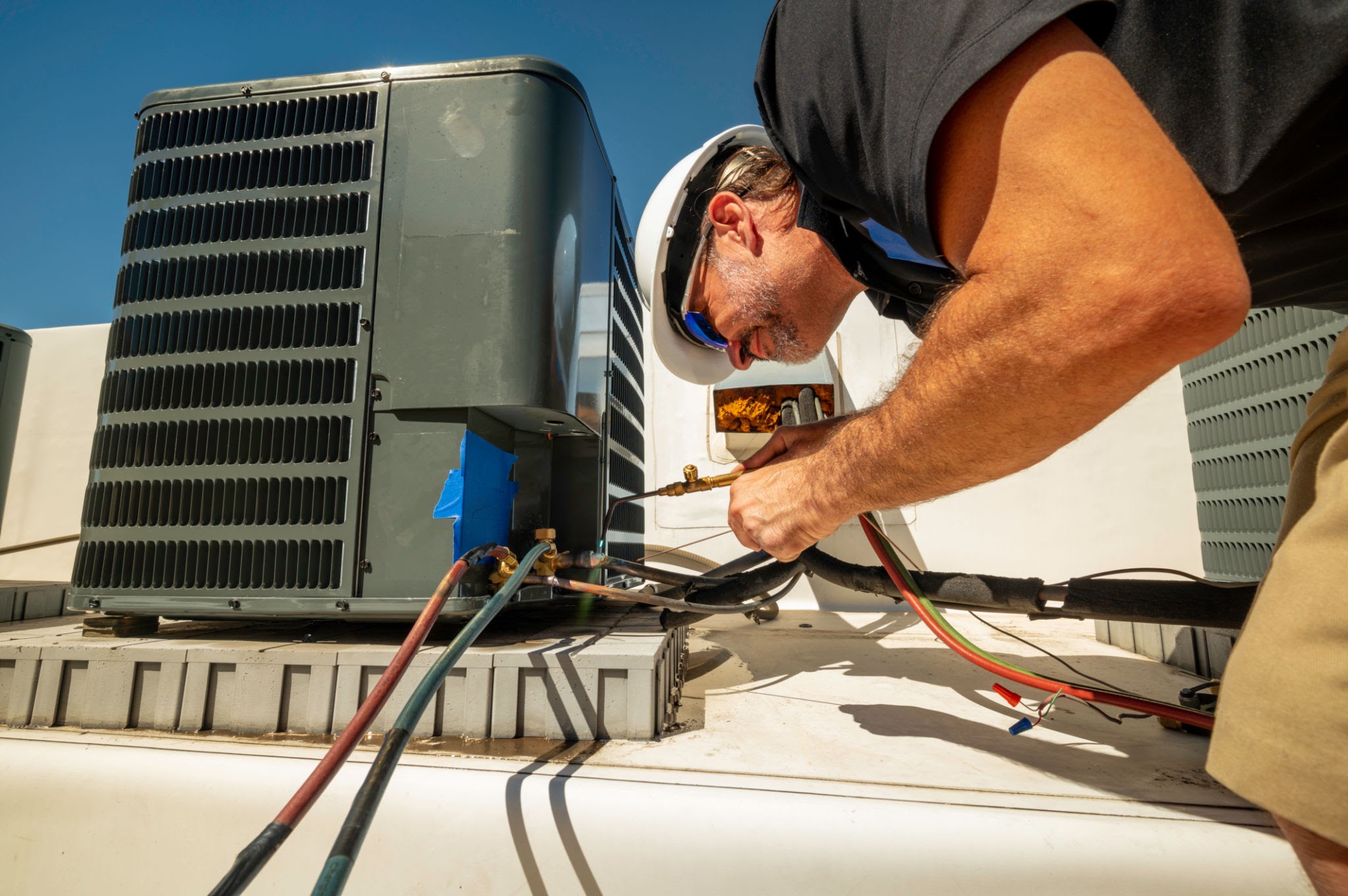 Air conditioning technician brazing a copper line set after a repair